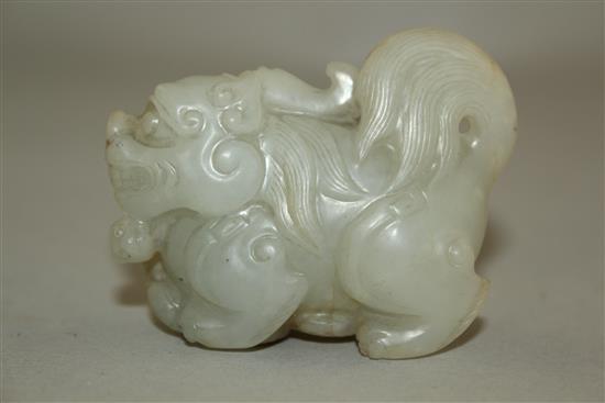 A Chinese pale celadon jade group of a lion-dog and a snake, 6.3cm